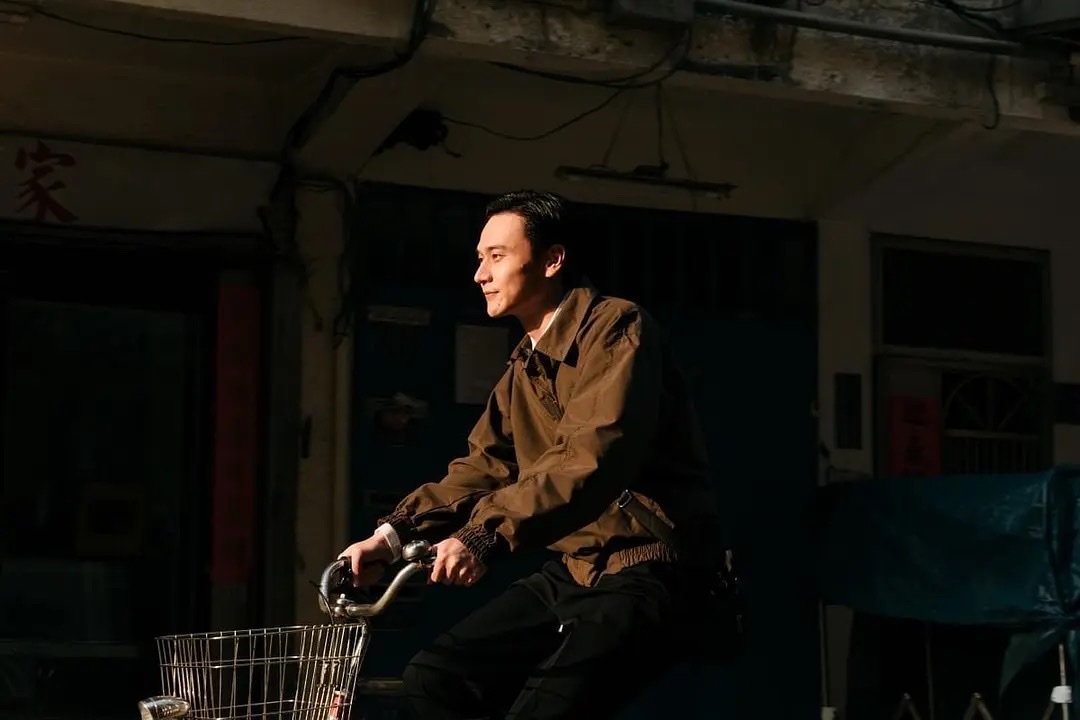 夕阳下骑车穿过旧巷的父亲廖泰来